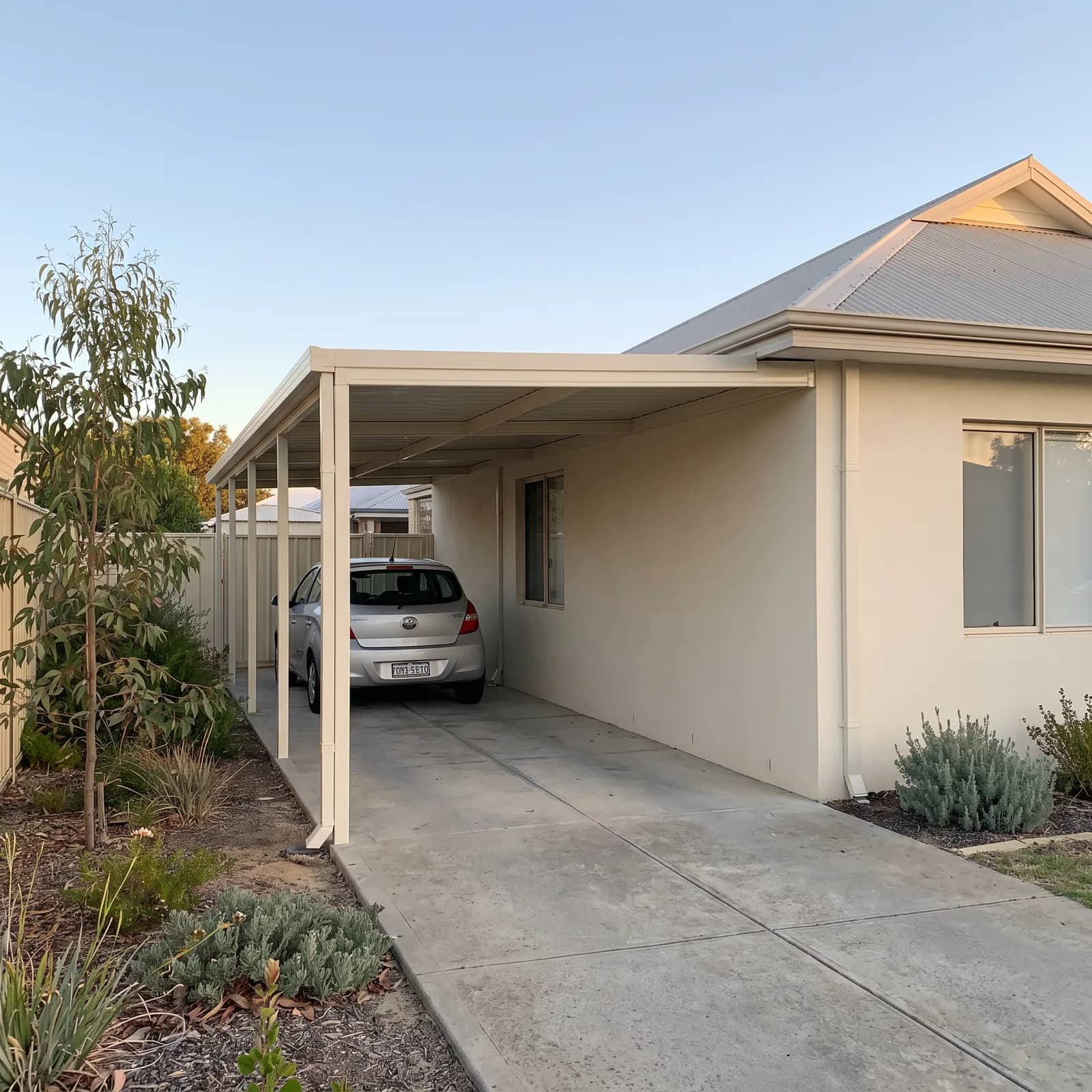 A single flat-roof Colorbond carport beside a Perth home
