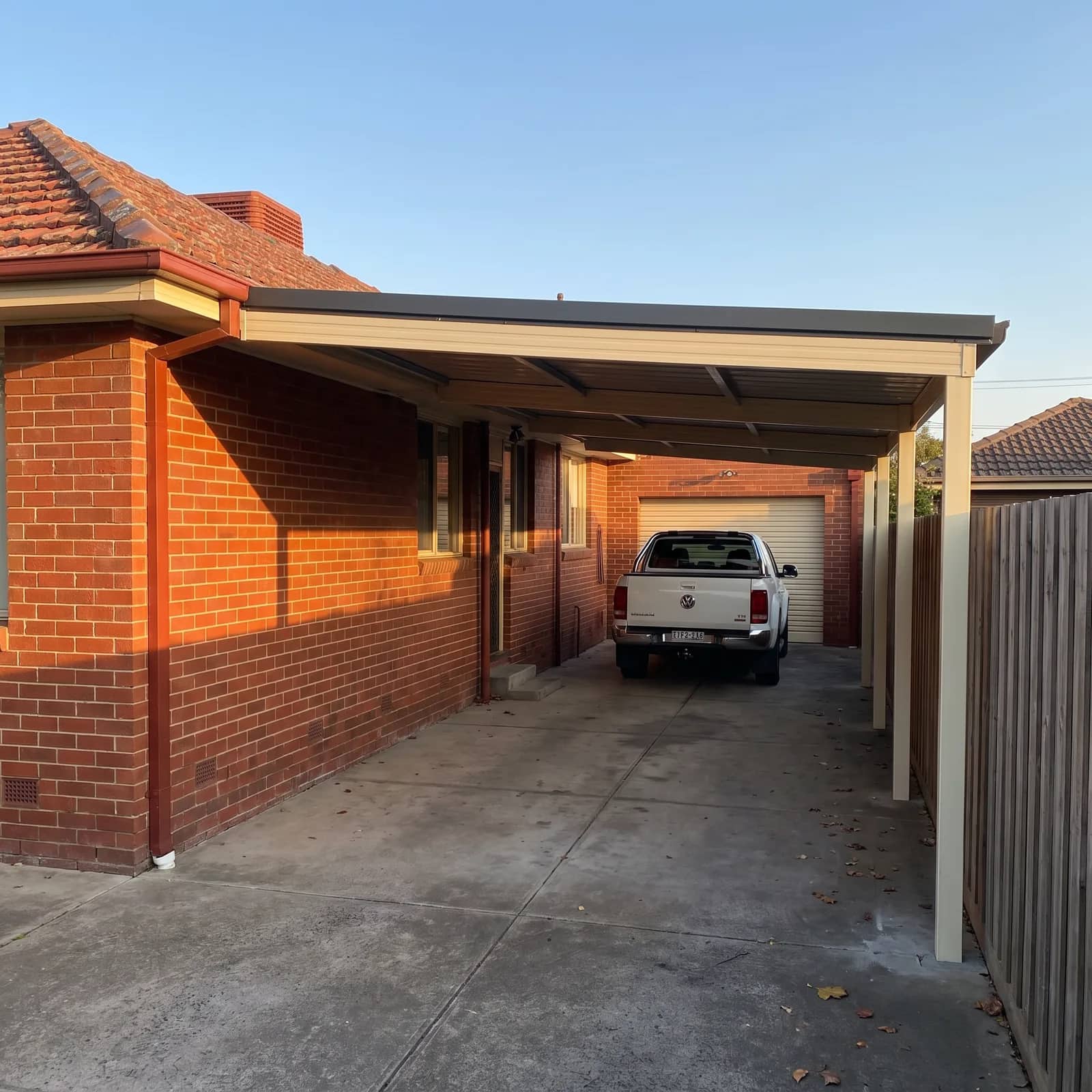A flat-roof Colorbond carport beside a Perth home