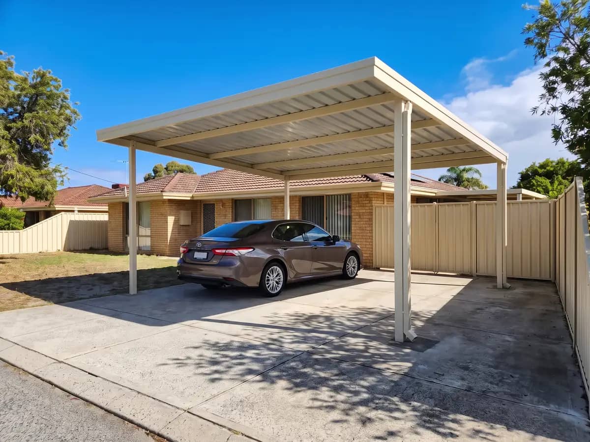 A freestanding Colorbond carport on its own posts on a Perth driveway