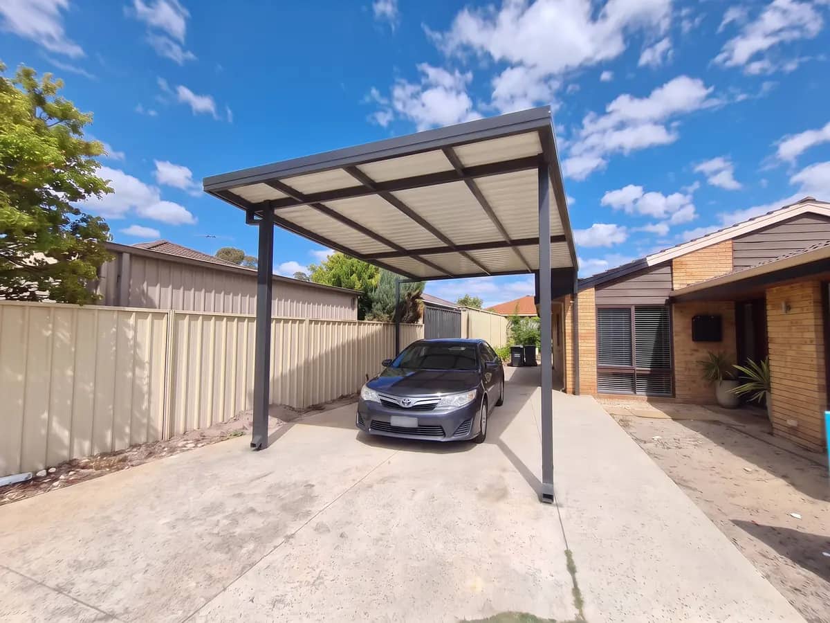 A single flat-roof Colorbond carport beside a Perth home