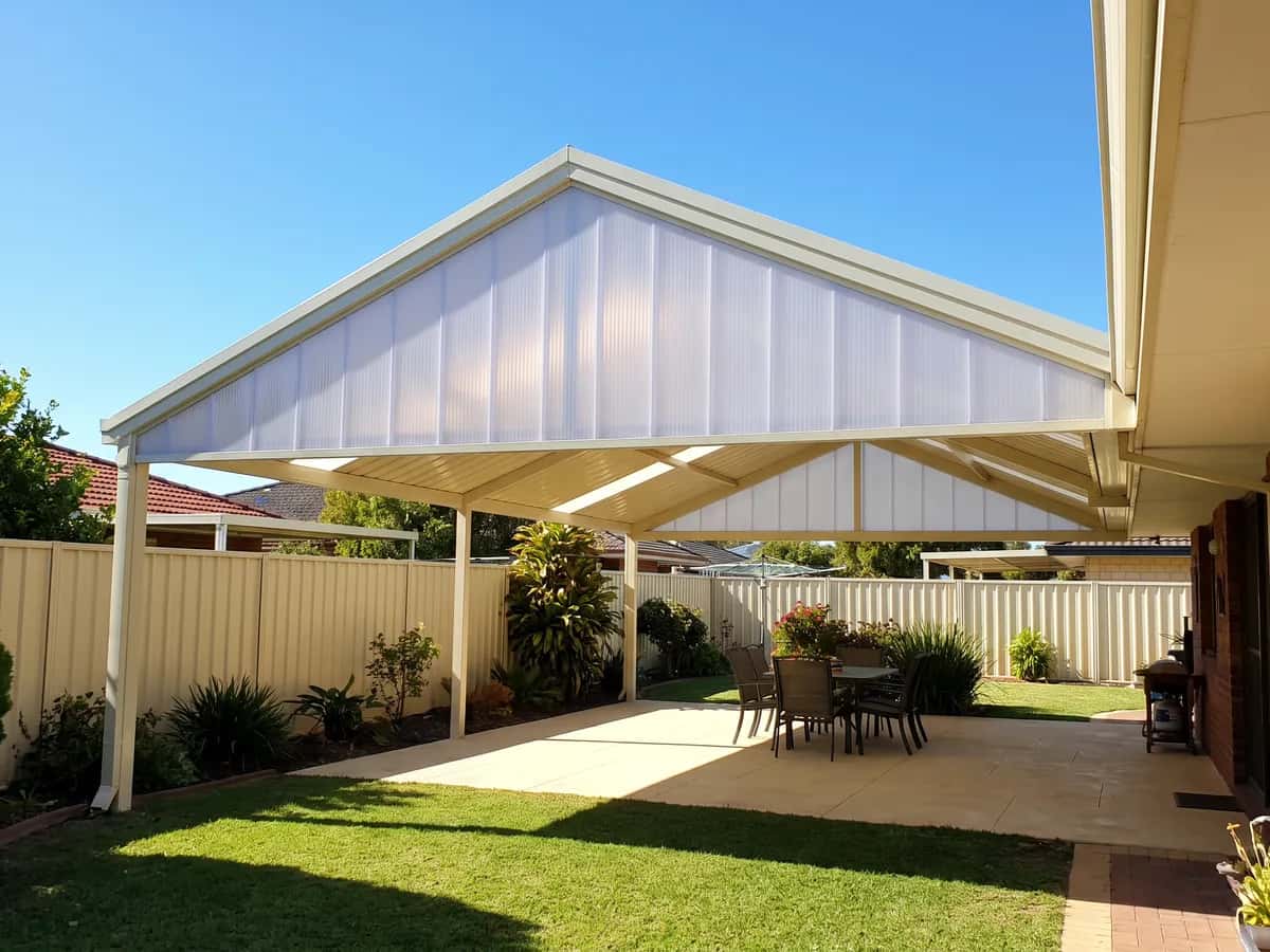 A patio photographed from far enough back that the whole area and the house behind it fit in one frame