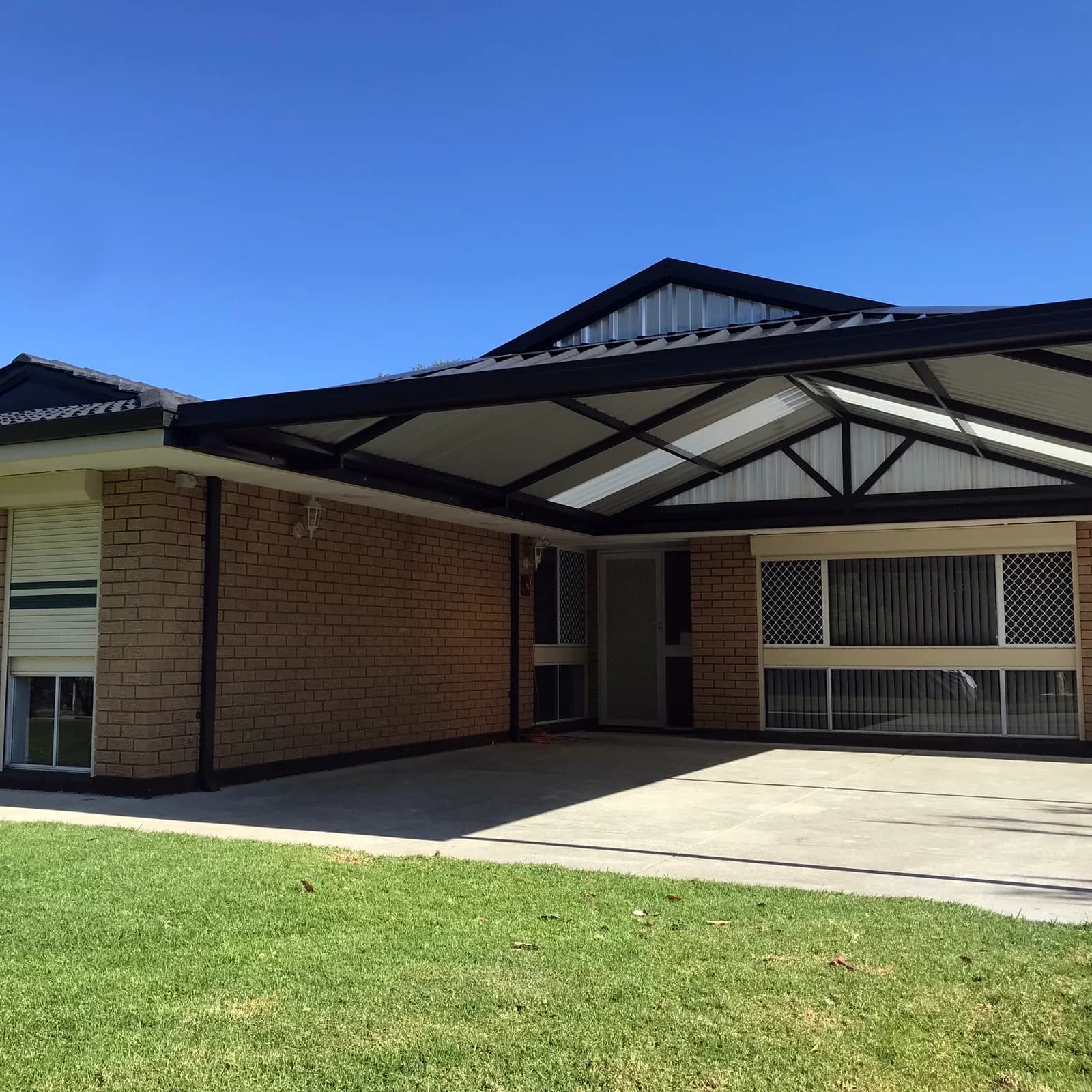 A gable roof patio on a Perth brick home, the ridge running out from the house over the driveway